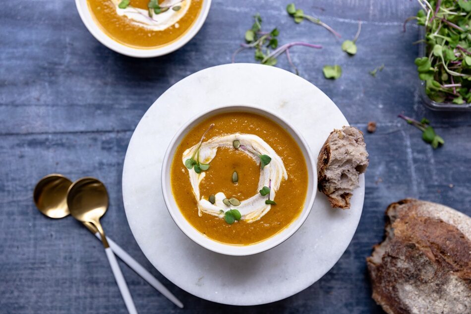 Photo of Butternut Squash Soup with Spiced Cream: A smooth soup topped with a dollop of cream spiced with nutmeg and cinnamon.
