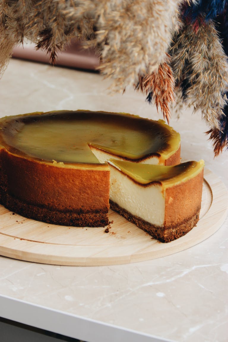 A close-up of a scrumptious cheesecake slice on a wooden tray with soft lighting.