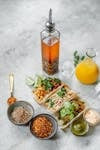 A delicious spread of Mexican tacos with sauces and vibrant spices, perfect for food enthusiasts.