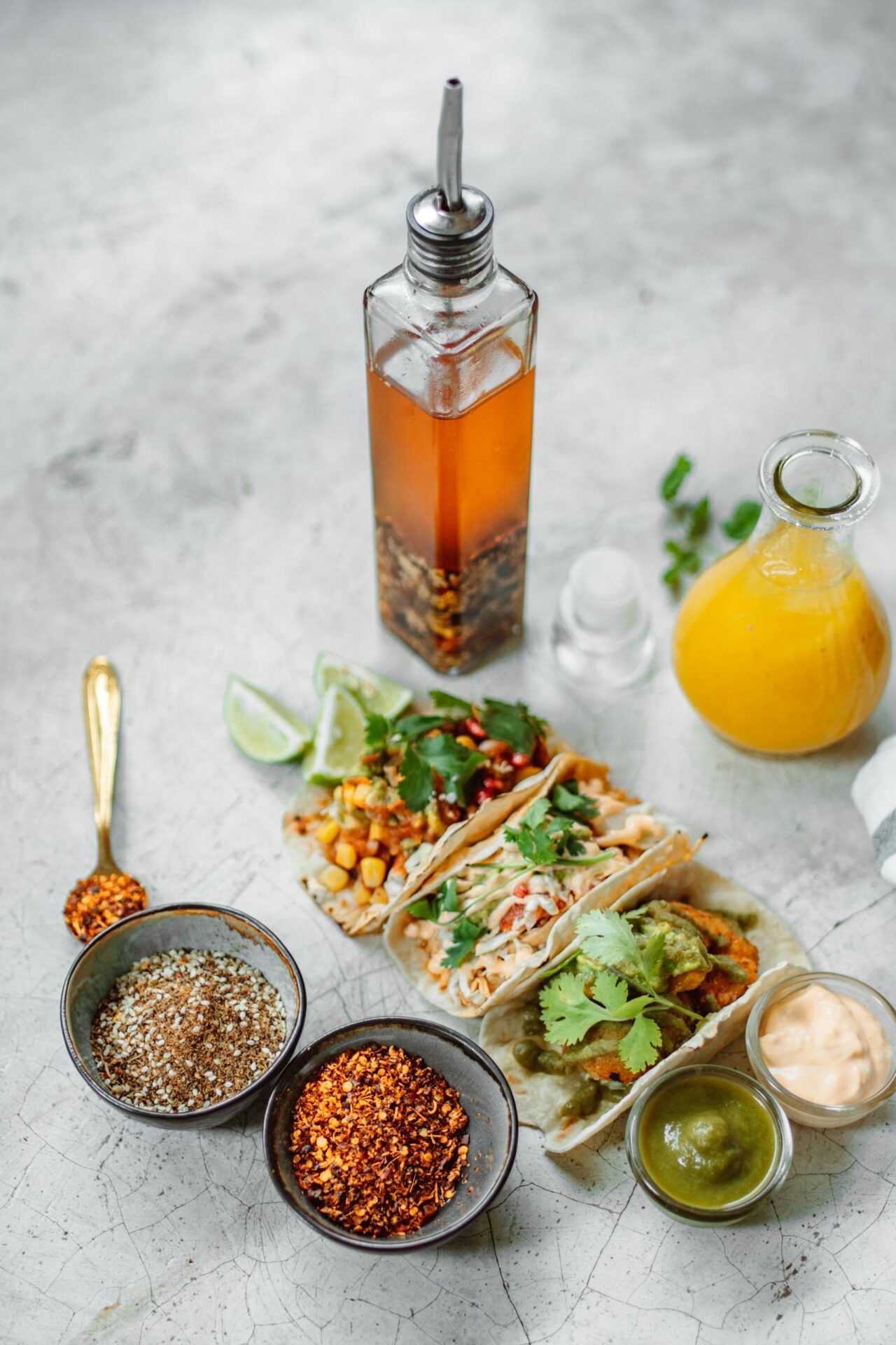 A delicious spread of Mexican tacos with sauces and vibrant spices, perfect for food enthusiasts.