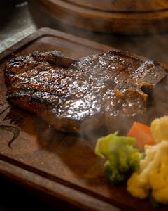 A deliciously grilled steak served with fresh steamed broccoli and cauliflower.