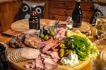 A delightful spread of meats, cheeses, and pickles paired with beer, perfect for Oktoberfest celebrations.