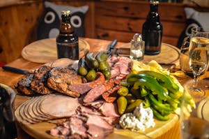 A delightful spread of meats, cheeses, and pickles paired with beer, perfect for Oktoberfest celebrations.