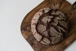 A high-angle view of a rustic round loaf of artisan bread on a wooden cutting board.