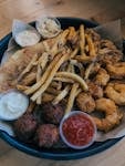 A mouthwatering assortment of fried seafood, coleslaw, and tartar sauce.