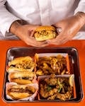 A tempting flat lay of fried food including burgers, fries, and chicken.