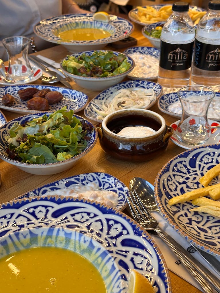 A vibrant display of traditional Turkish dishes set on a blue patterned tableware.