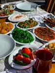 A vibrant Mediterranean meal displaying a variety of traditional dishes and fresh ingredients on a sunlit table.