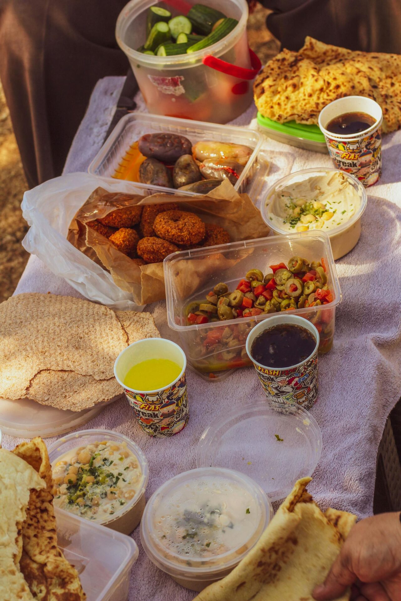 A vibrant spread of Middle Eastern dishes including falafel, salads, and dips in an outdoor setting.