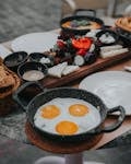 A vibrant Turkish breakfast with fried eggs, fresh vegetables, and more in Antalya.