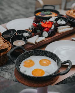 A vibrant Turkish breakfast with fried eggs, fresh vegetables, and more in Antalya.