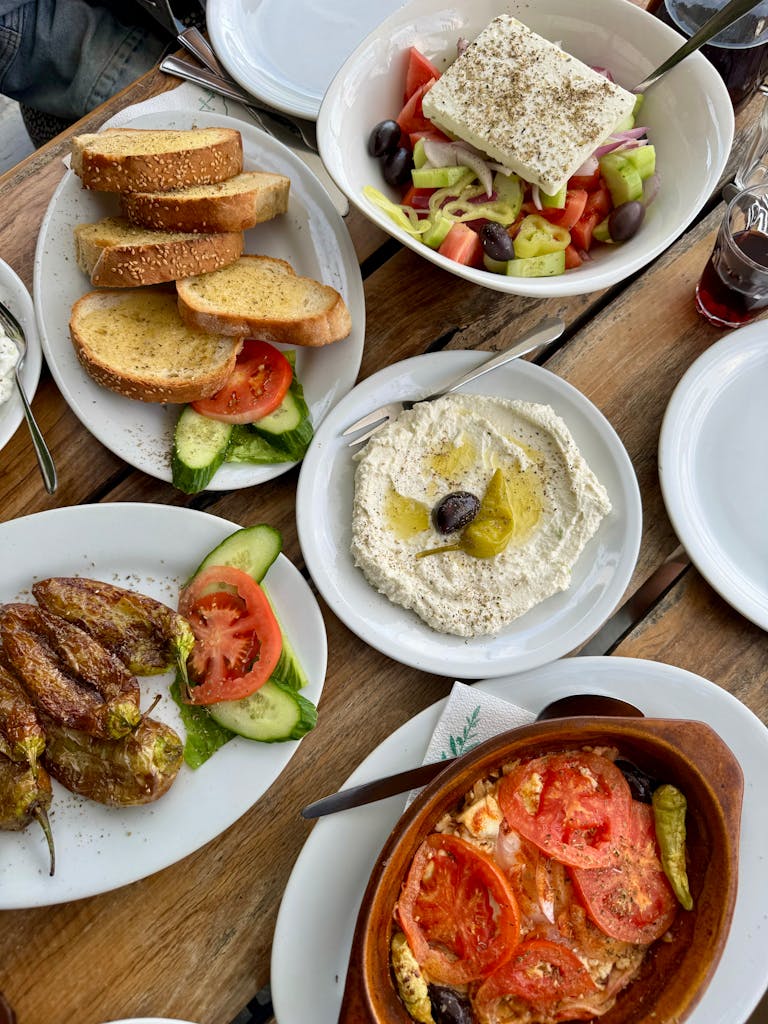 Authentic Mediterranean meal featuring mezze, salad, and breads on a rustic table.