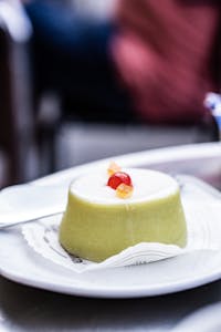 Close-up of a classic Cassata Siciliana dessert with candied fruits on a plate in Noto, Sicily.