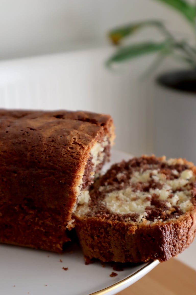 Close-up of a sliced homemade marble cake on a plate, perfect for breakfast or dessert.
