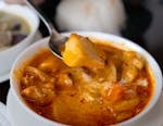 Close-up of a vibrant curry dish with fresh ingredients in a Tokyo restaurant setting.