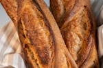 Close-up of freshly baked artisan baguettes from a Berlin bakery, showcasing their golden crust.