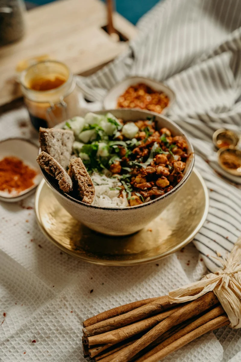 Chickpeas and rice with sliced cucumber, herbs and bread