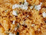 Delicious couscous salad topped with cheese and herbs. A perfect homemade dish featuring fresh ingredients.