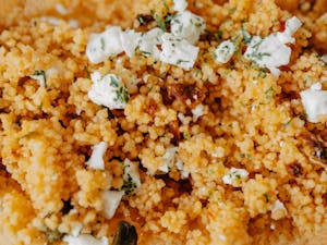 Delicious couscous salad topped with cheese and herbs. A perfect homemade dish featuring fresh ingredients.