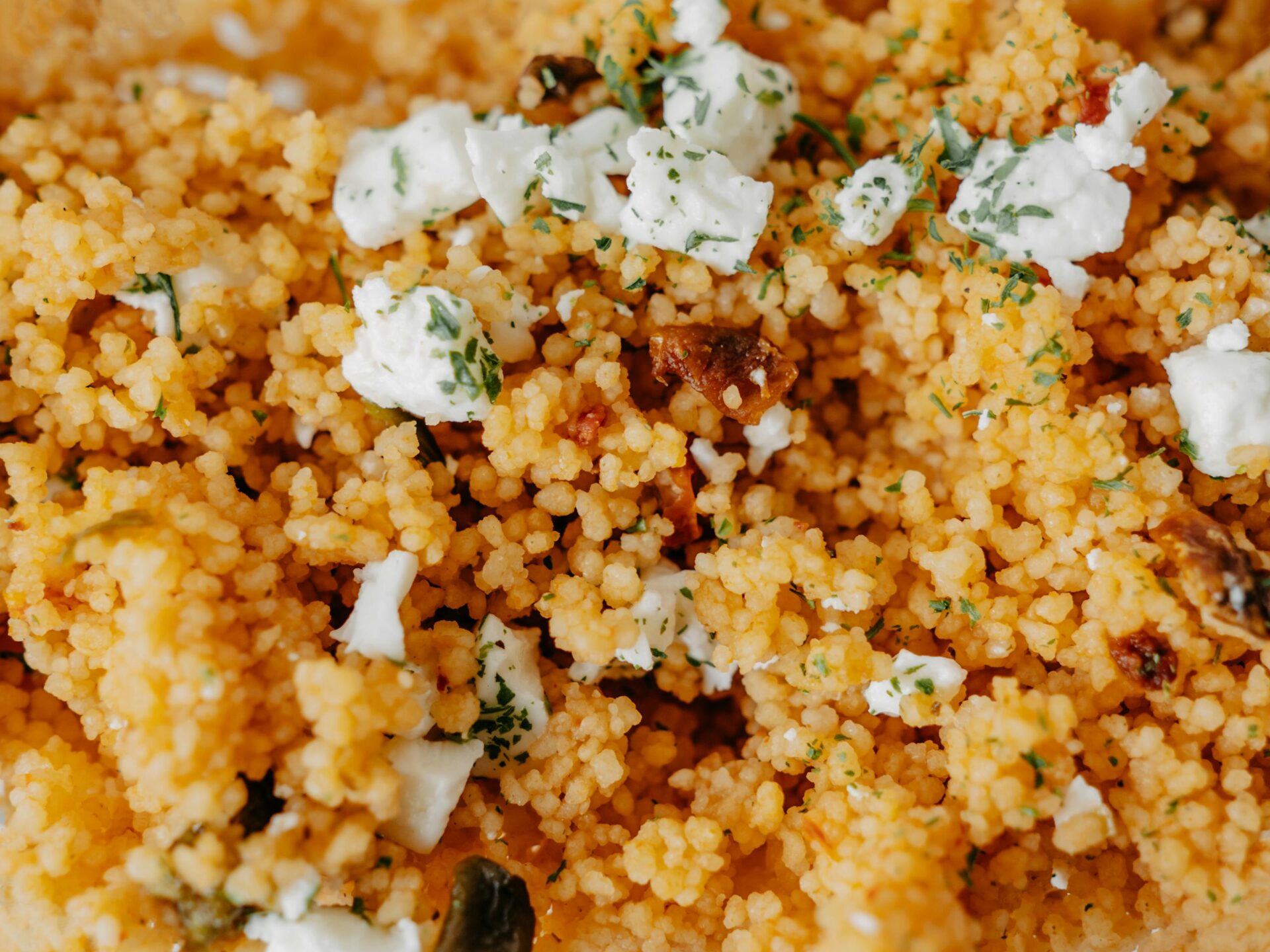 Delicious couscous salad topped with cheese and herbs. A perfect homemade dish featuring fresh ingredients.