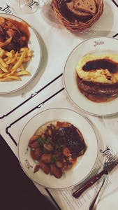 Delicious French dishes elegantly served on ceramic plates at a Parisian restaurant.