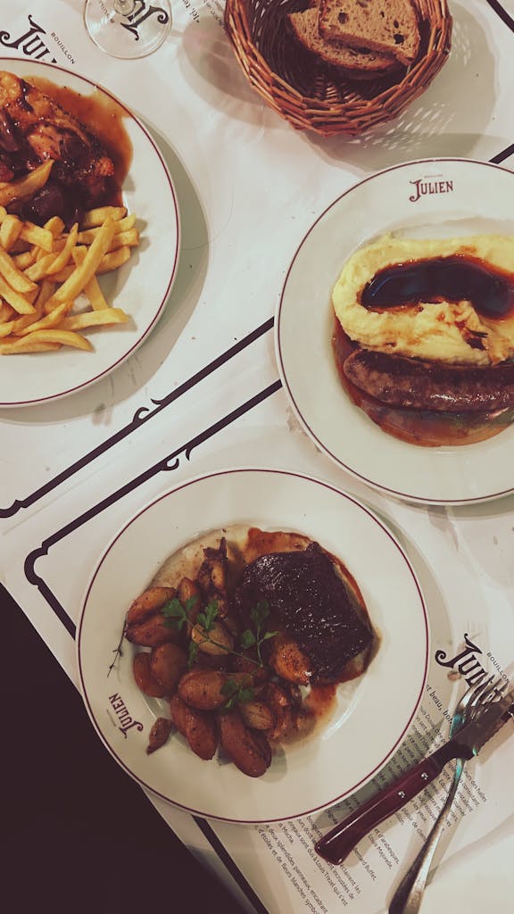 Delicious French dishes elegantly served on ceramic plates at a Parisian restaurant.