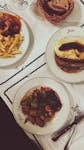 Delicious French dishes elegantly served on ceramic plates at a Parisian restaurant.
