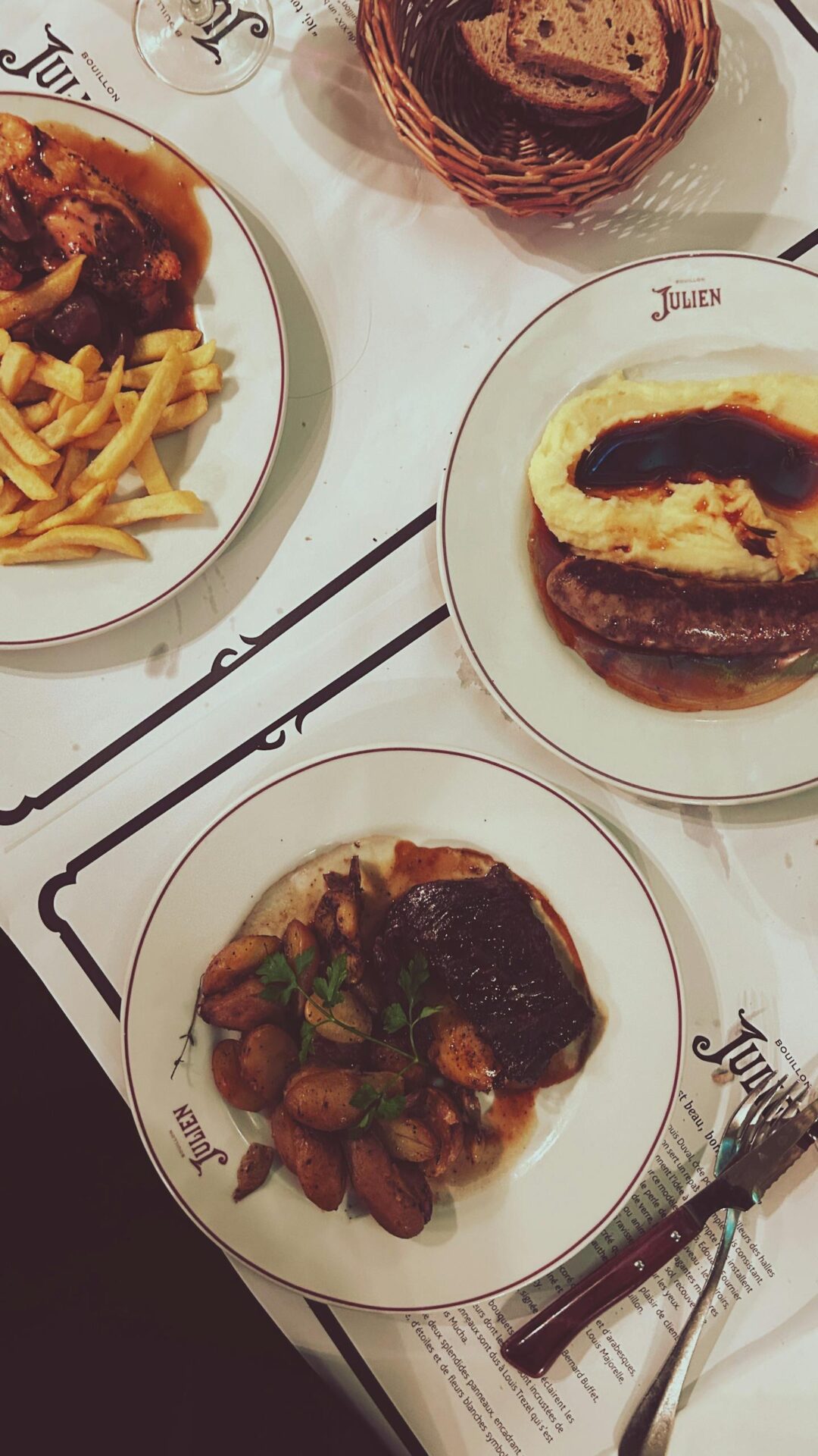 Delicious French dishes elegantly served on ceramic plates at a Parisian restaurant.