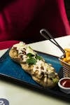 Delicious gourmet sandwich with melted cheese and fries, perfect for a hearty meal.