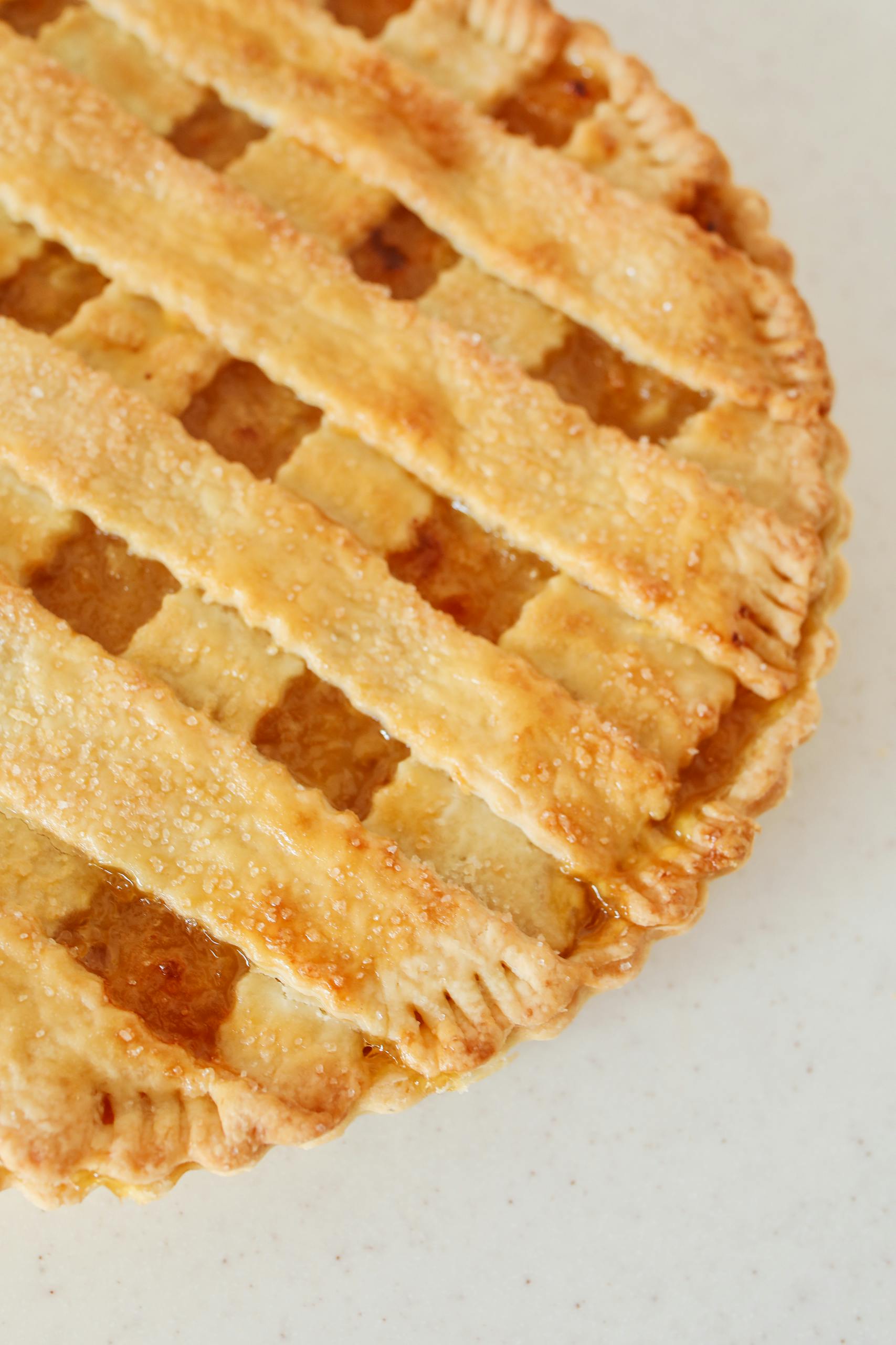 Delicious homemade apple pie with a golden lattice crust, captured from above.