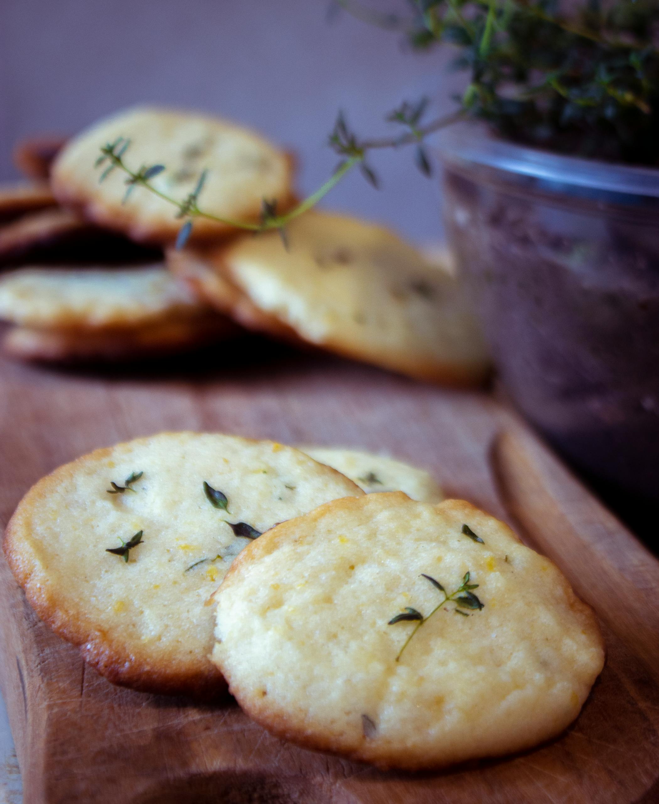 Delicious homemade cookies with herbs on a wooden board, perfect for a savory treat.