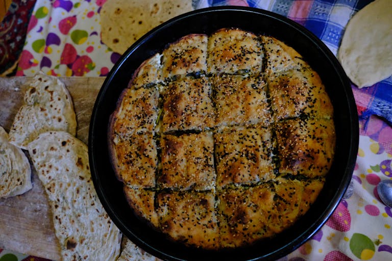 Delicious homemade flatbread served with a freshly baked sesame seed-topped pastry.