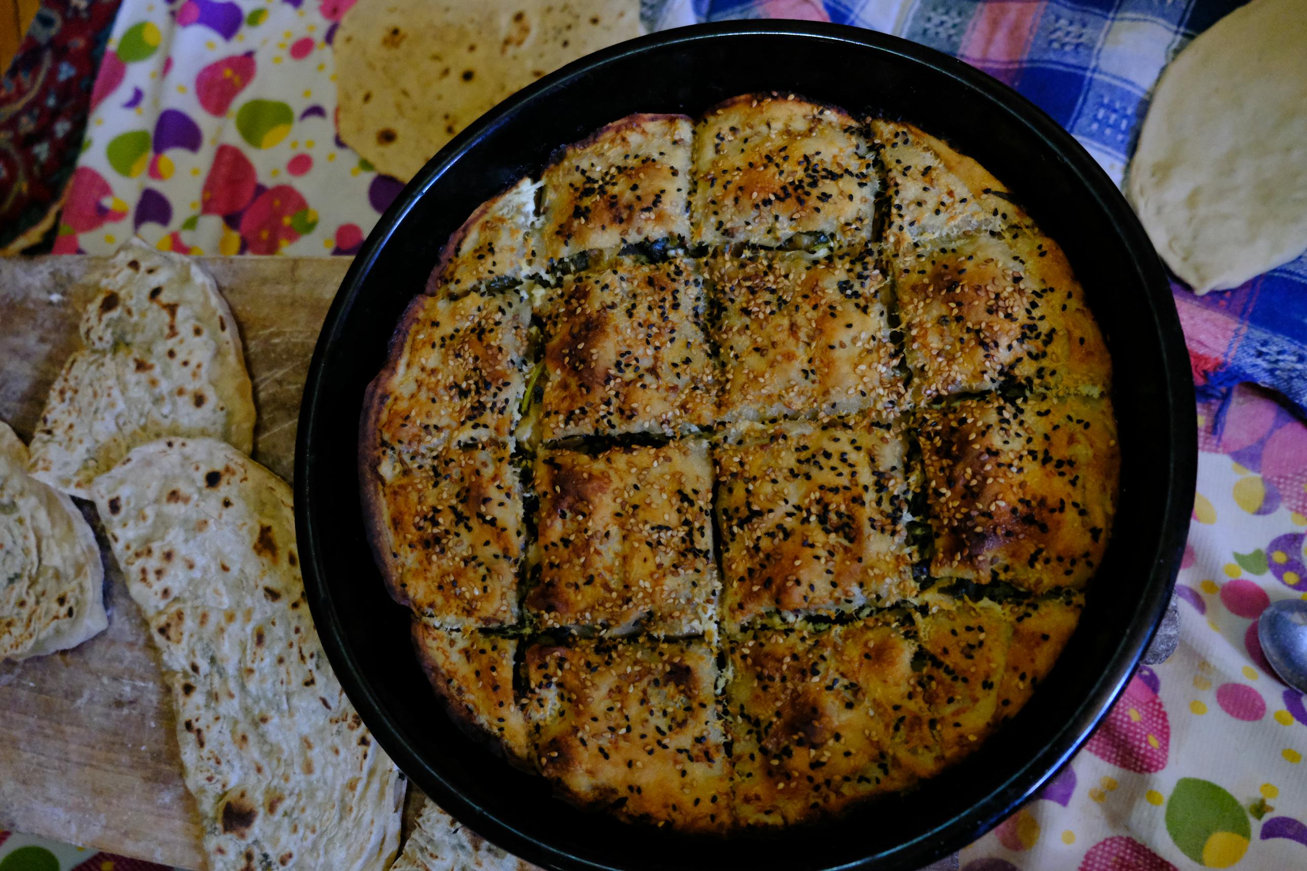 Delicious homemade flatbread served with a freshly baked sesame seed-topped pastry.