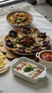 Delicious Mediterranean feast with a variety of dips and roasted vegetables.