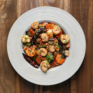 Delicious shrimp and vegetable dish served on a white plate, perfect for a gourmet meal.