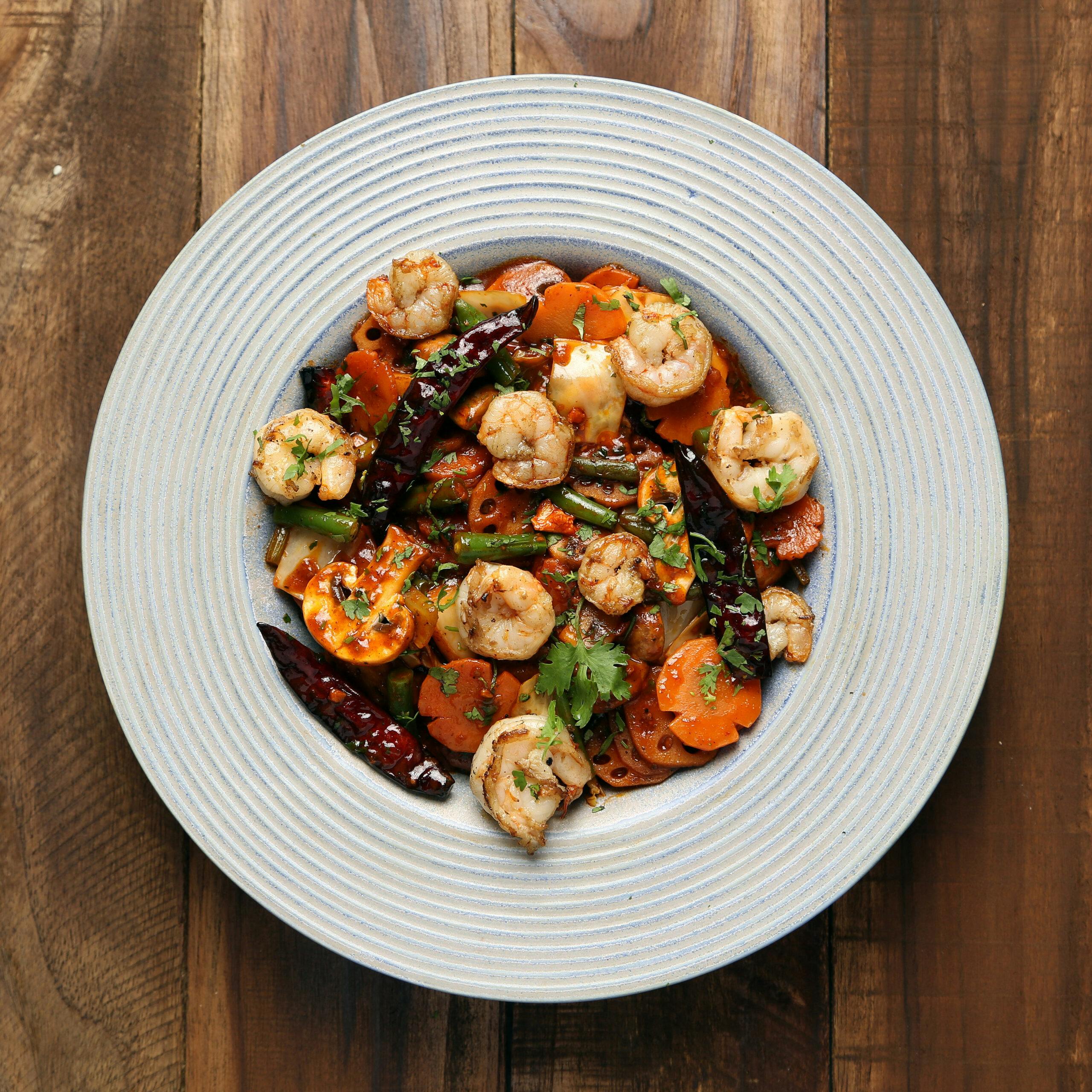 Delicious shrimp and vegetable dish served on a white plate, perfect for a gourmet meal.