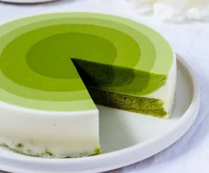 Matcha green tea mousse cake with a slice cut out