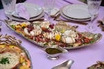 Elegant dinner setting featuring gourmet burrata cheese with vibrant garnish. Perfect for culinary inspiration.