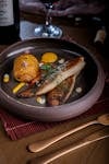 Gourmet fish and potato dish elegantly presented in São Paulo restaurant.