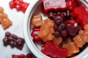 Mixed-color gummy bears in a white porcelain ramekin