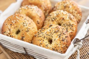 Sesame bagels in a lined basket