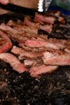Juicy grilled steak slices on a rustic grill, capturing authentic Brazilian BBQ vibes.
