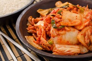 Bowl of napa kimchi with white rice.