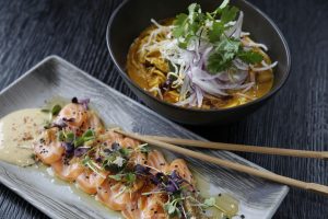 Salmon sashimi with noodles, cilantro, and sliced red onion