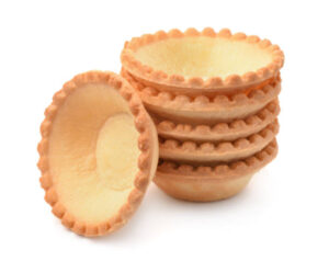 Stack of empty tart shells on a white background.