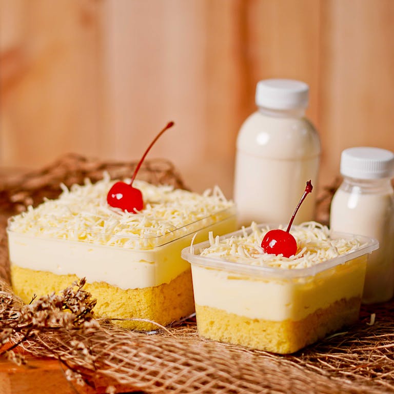 Tempting layered cake topped with cherries and cheese, perfect for dessert lovers.