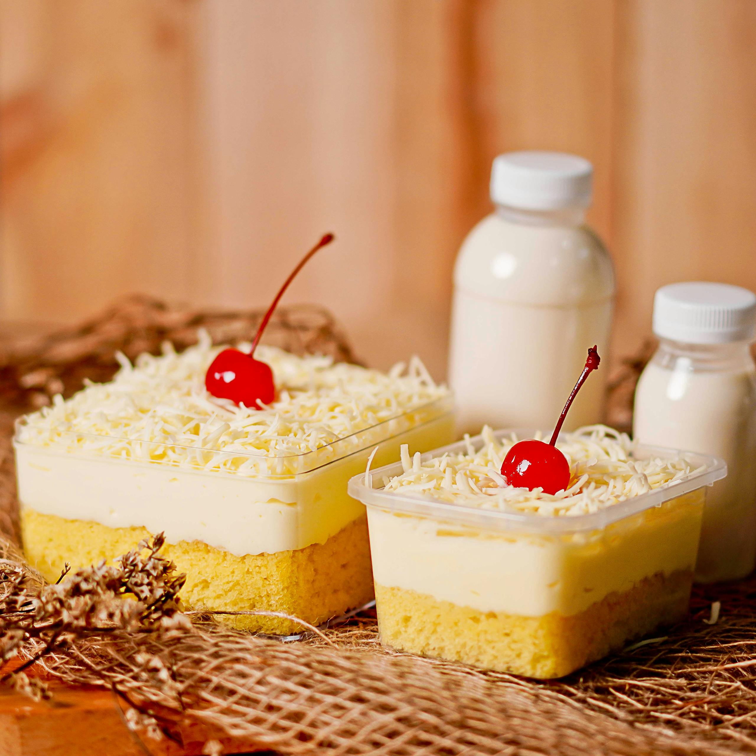 Tempting layered cake topped with cherries and cheese, perfect for dessert lovers.