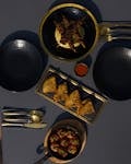 Top view of a sophisticated dining setup with skewers, appetizers, and elegant tableware.